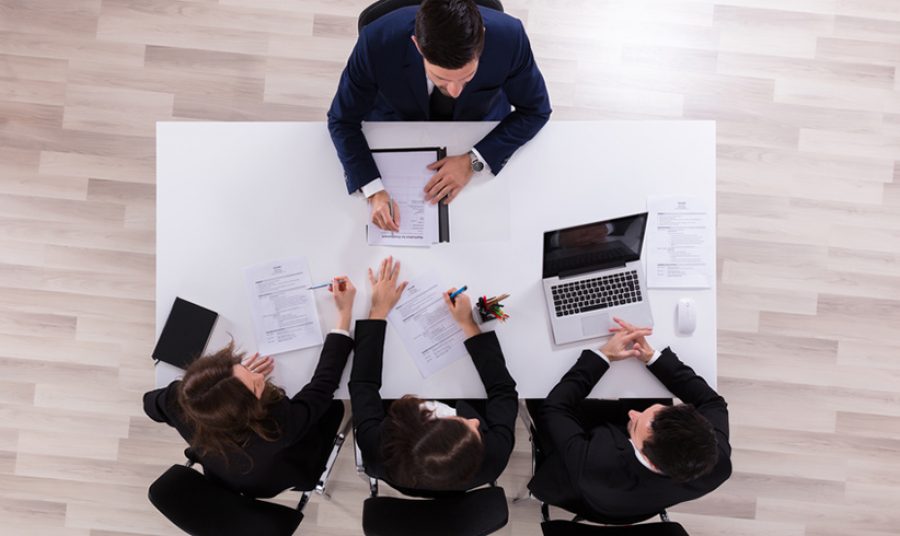 Businesspeople Interviewing Male Candidate