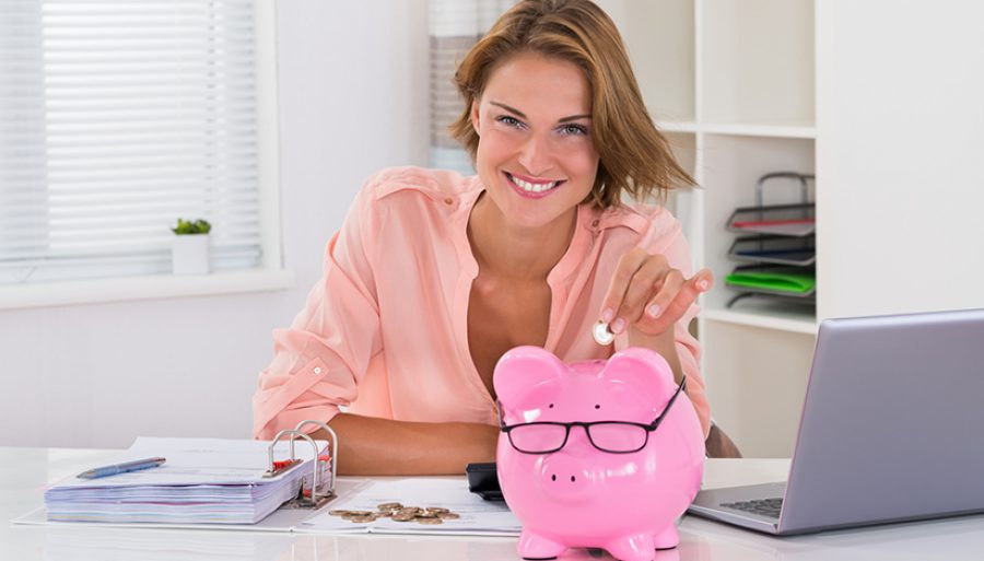 Woman Putting Coin In Piggybank
