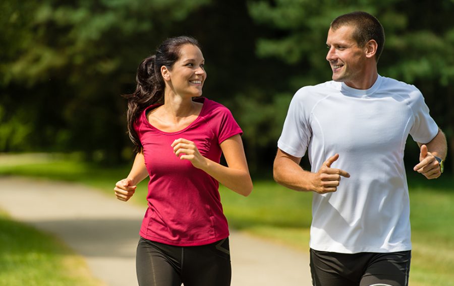 Cheerful Caucasian couple running outdoors