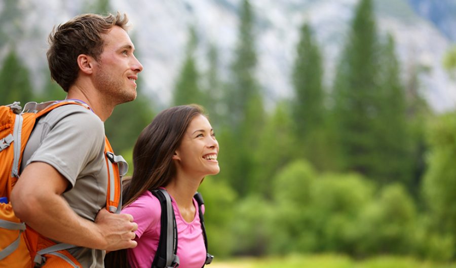 Couple - active hikers hiking in Yosemite