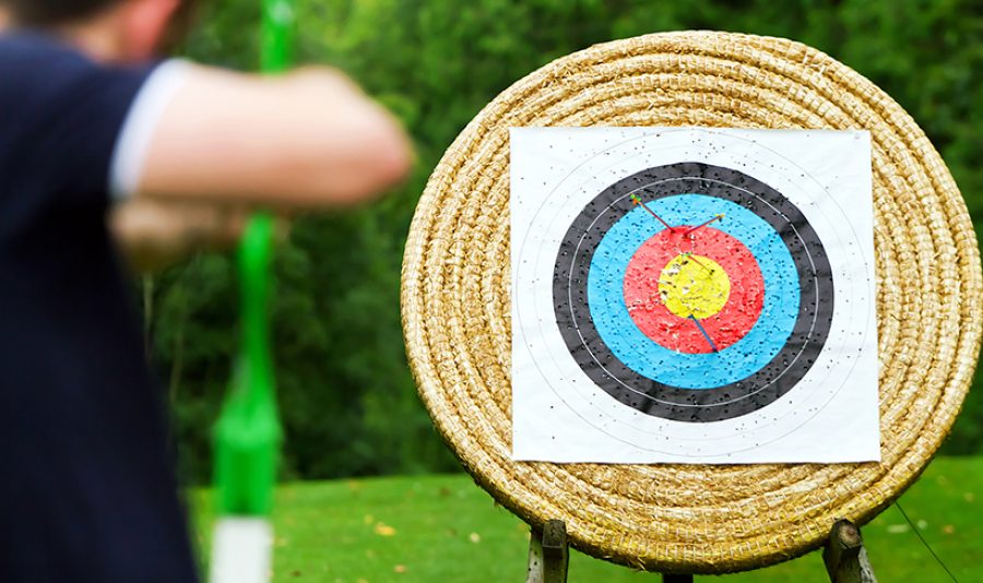An archer takes aim at target