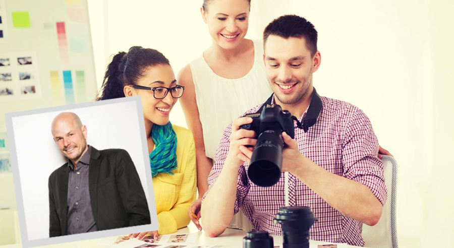 smiling team with photocamera working in office
