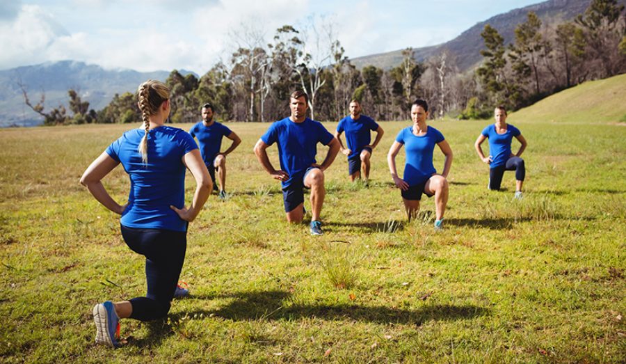 Female trainer giving training to fit people