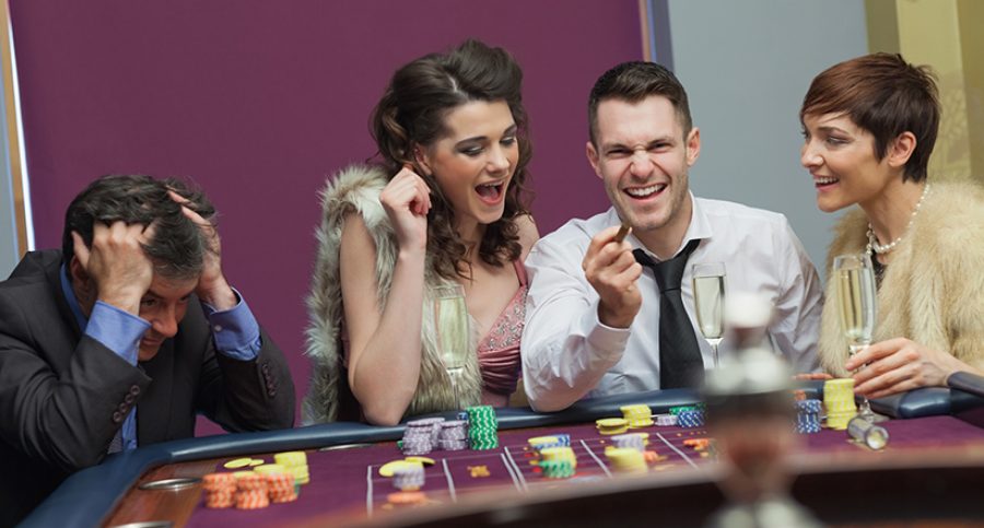 Winner and loser at roulette table in casino