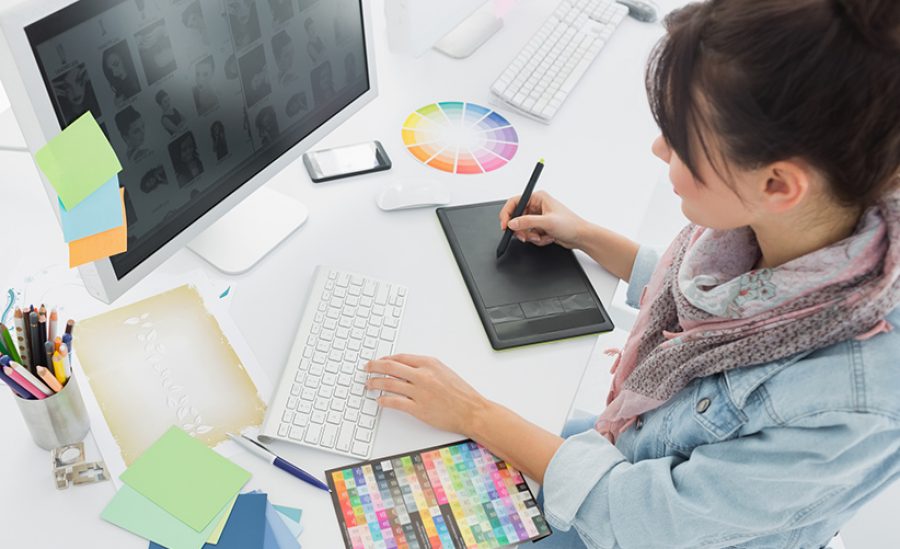 High angle view of an artist drawing something on graphic tablet at the office