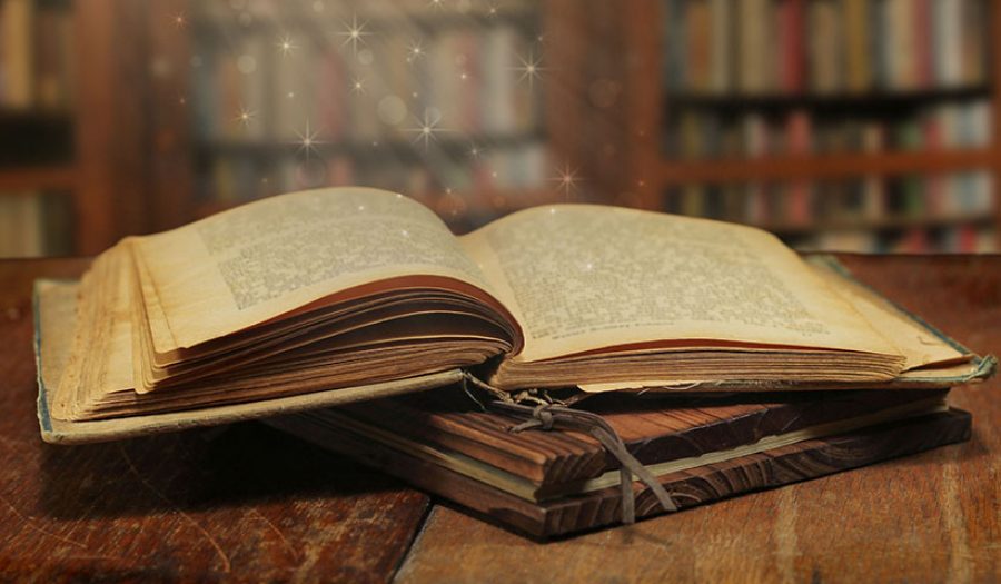 Opened magic book with magic light
