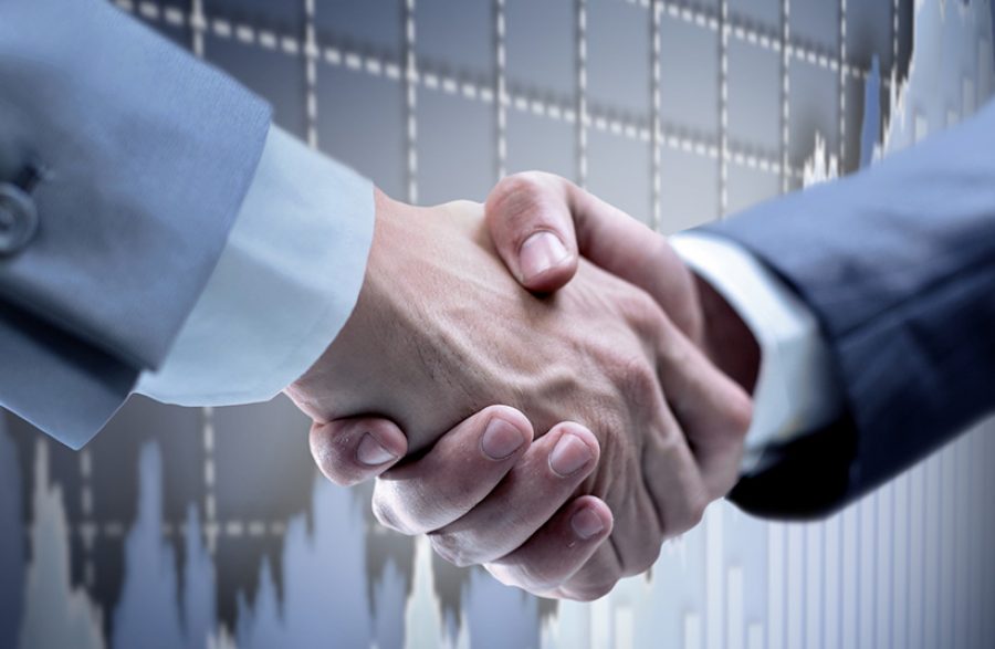 Handshake - Hand holding on black background