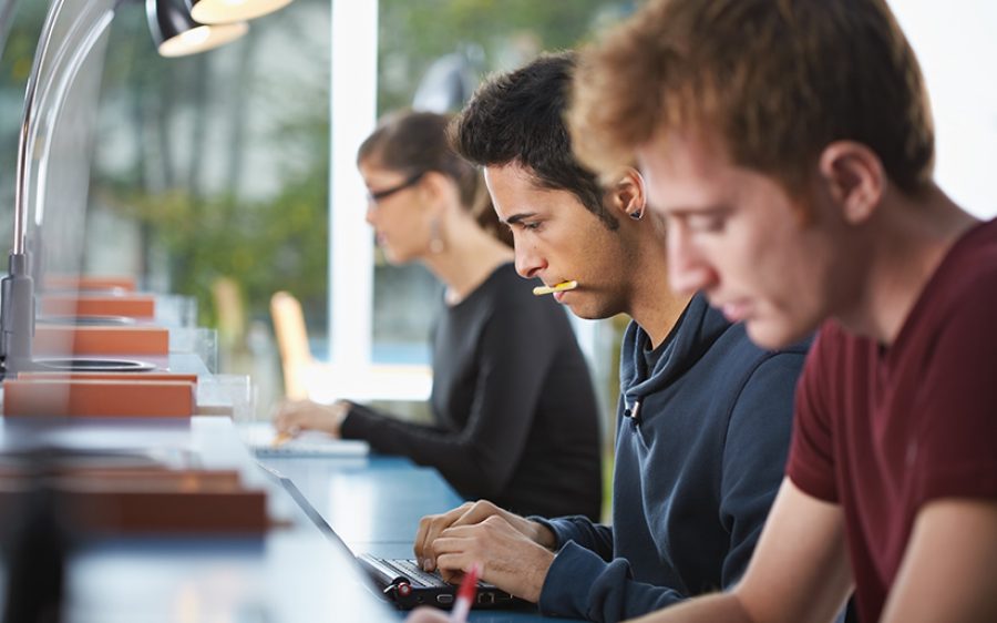 Group of three people in library