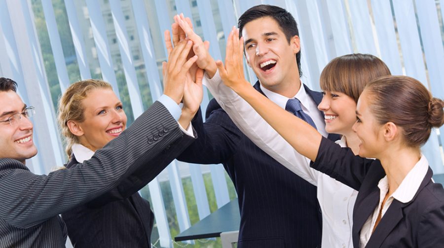 Happy successful gesturing business team at office