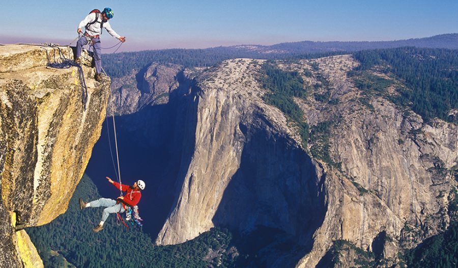 Team of climbers reaching the summit.