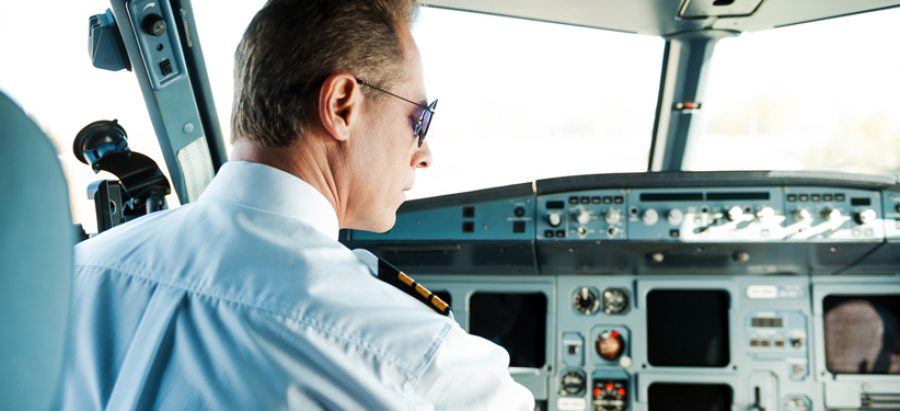 Ready to take off. Rear view of confident male pilot sitting in