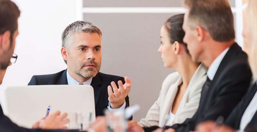 Business meeting. Business people in formalwear discussing somet