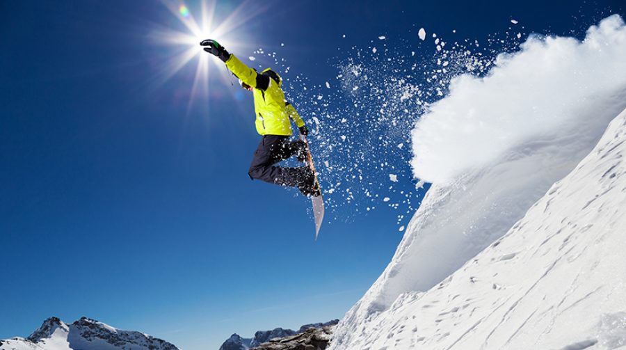 Alpine skier on piste, skiing downhill