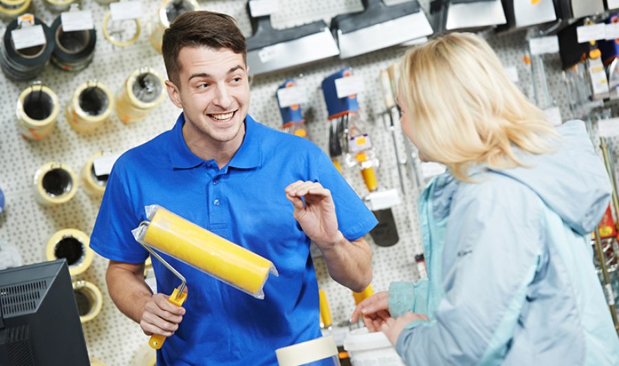 Seller demonstrating paint roller to buyer