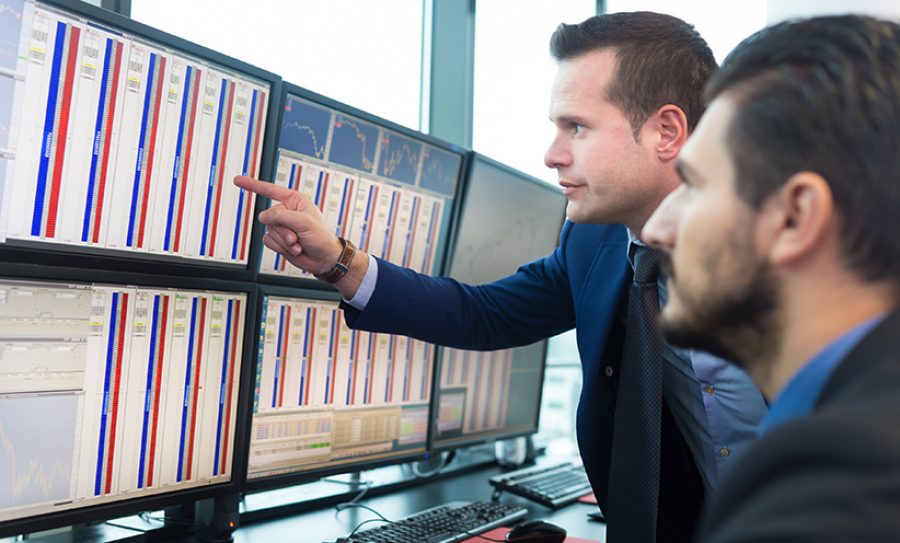 Stock traders looking at computer screens.