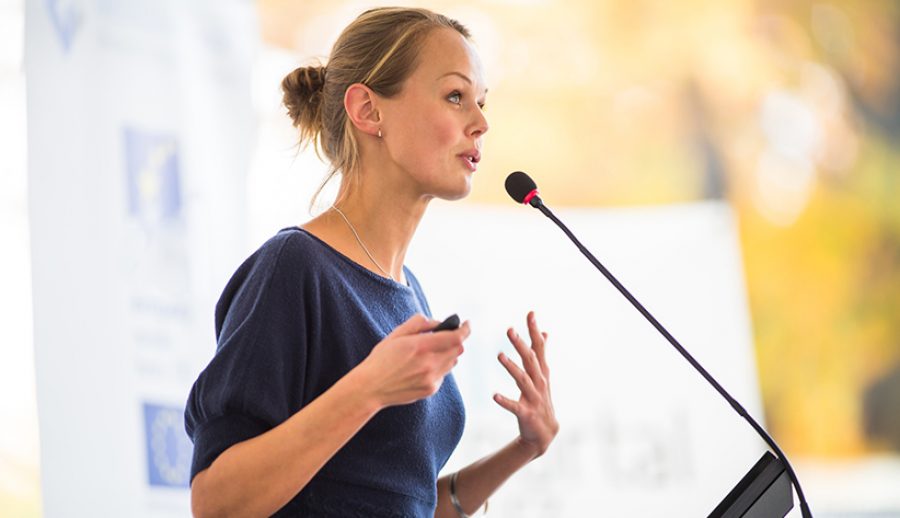 Pretty, young business woman giving a presentation in a conferen
