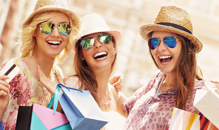 Group of happy friends shopping in the city