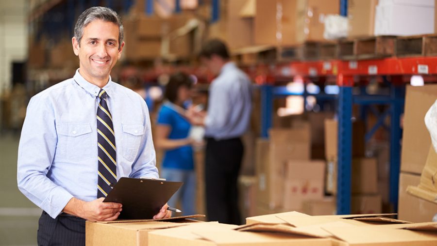 Manager In Warehouse Checking Boxes