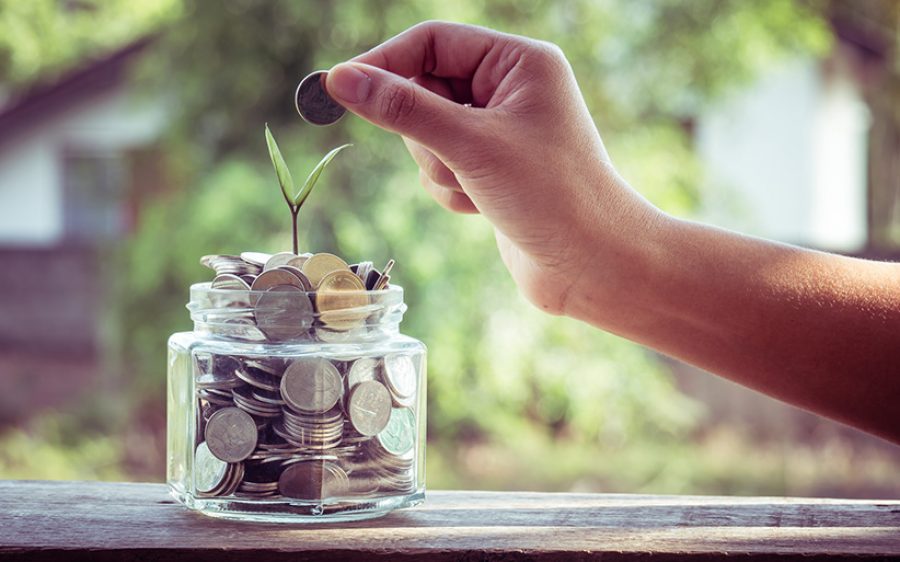 hand putting money coins  with filter effect retro vintage style