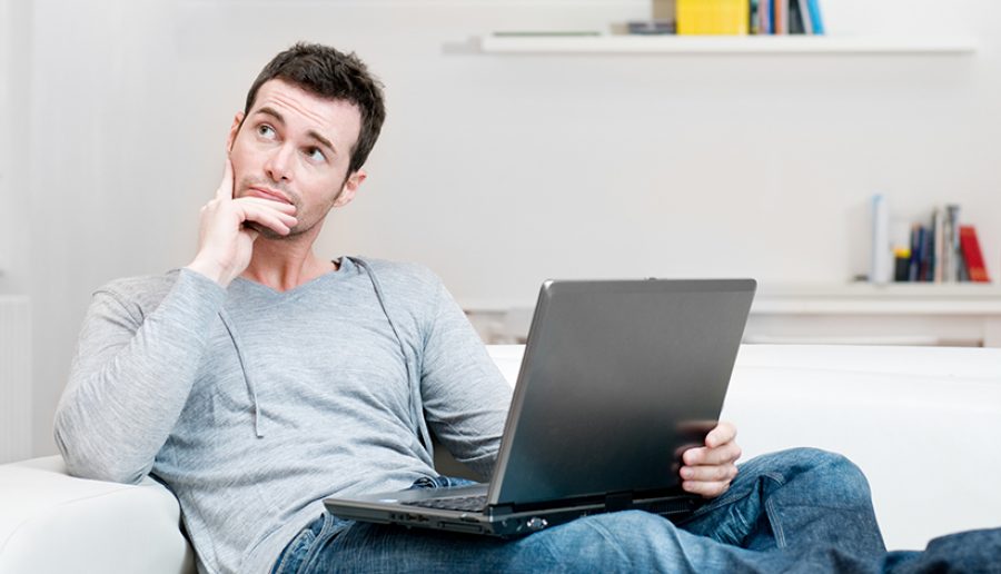 Absorbed and confused man on laptop