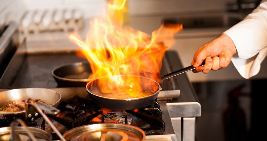 Chef cooking in kitchen stove
