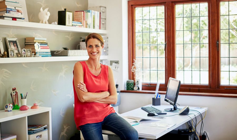 Confident woman sitting on desk