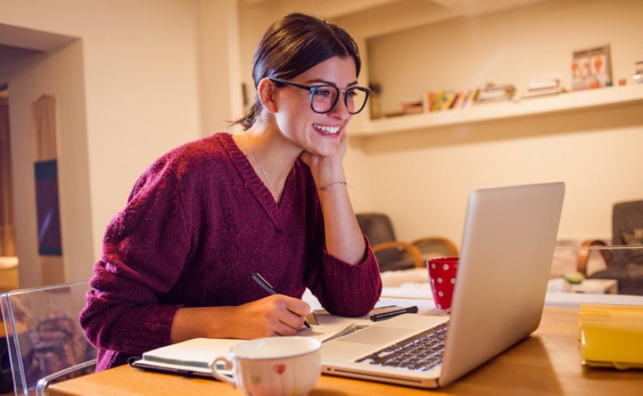 beautiful smiling woman using her computer